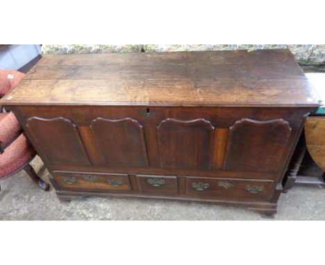 A 4' 9 1/2" antique oak and cross banded mule chest with applied panelling to front, flanking reeded quarter columns and thre