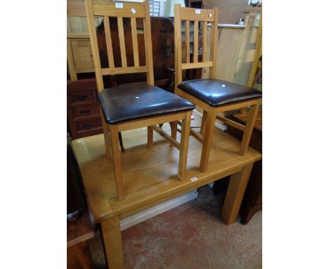 A 3' 11" modern solid oak dining table with bracketed top, set on heavy square legs - sold with a set of four Julian Bowen st