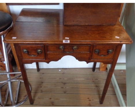 A 30 1/2" polished oak lowboy with moulded top, three frieze drawers and shaped apron, set on chamfered square legs