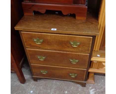 A 26 1/2" polished oak chest of three long graduated drawers, set on bracket feet