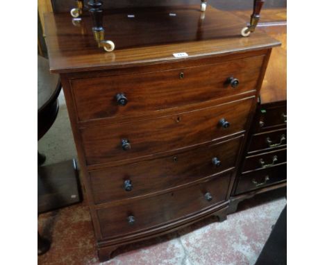 A 27 1/2" Maple &amp; Co. mahogany slightly bowed front chest of four long graduated drawers and bearing original metal label