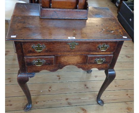 A 28" antique polished oak lowboy with frieze drawer and two further short drawers to shaped apron, set on cabriole legs with