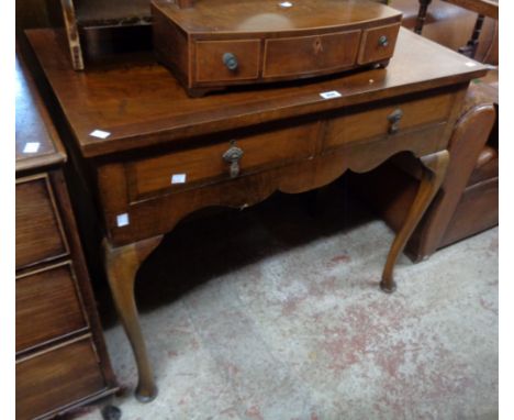 A 36" early 20th Century mahogany and mixed wood lowboy with cross banded top and two frieze drawers, set on cabriole front l