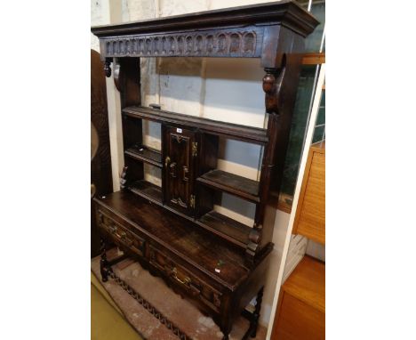A 48 1/2" antique oak dresser, the associated top with open shelves and central cupboard, over a base with two frieze drawers