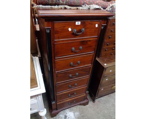 A 24" Eastern polished hardwood chest in the Recency style, with flanking ebonised columns and flight of seven drawers, set o
