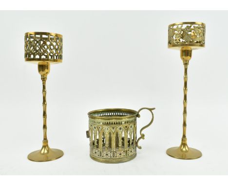 Three Victorian late 19th century Gothic style ecclesiastical candlestick holders. The candle holders comprising two tall pil