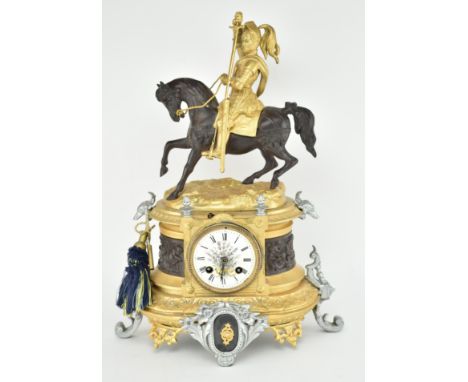 An early 20th century continental, likely French, gilt chrome mantlepiece clock featuring a knight finial. The clock with gil