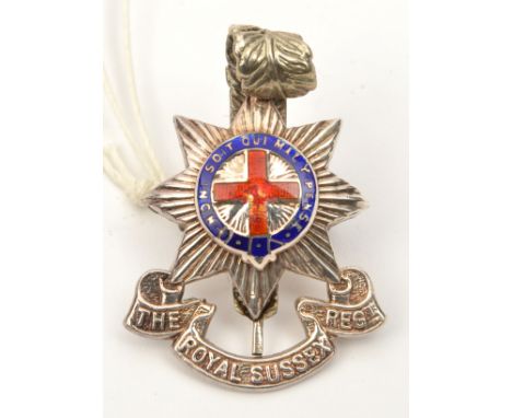 An officer’s enamelled cap badge of The R Sussex Regt, marked L&amp; Co, Sterling. Basically GC (red enamel cross chipped).  