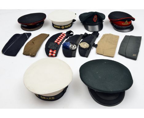An officer’s blue peaked cap of The R Artillery, scarlet piping and headband, gilt badge and buttons (peak crazed) and a simi