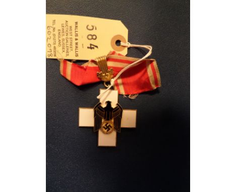A Third Reich gilt and enamel Social Welfare decoration, 1st class, with gilt suspension ring and short length of ribbon. GC 