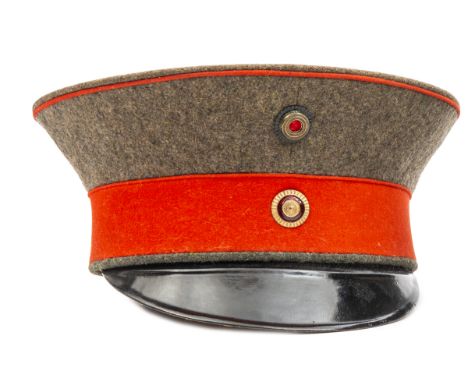 An Imperial German Baden General’s peaked cap (feldmutze), with field grey crown, scarlet band and piping, black fibre peak, 