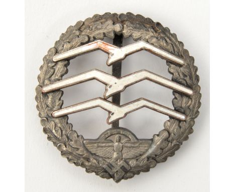 A Third Reich NSFK large glider pilot’s badge, of silvered metal with white enamelled birds, the reverse marked “Eigentum des