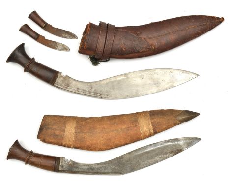 A kukri,  blade 12”, darkwood grip with a little decoration, in leather scabbard with 2 companion knives and studded belt loo