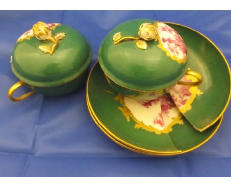 A pair of 19th Century Berlin porcelain chocolate cups and saucers with puce decoration on a green ground CONDITION REPORTS O
