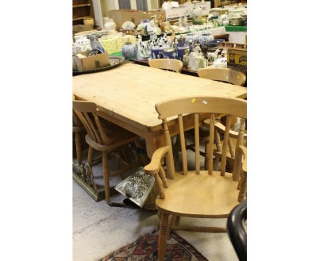 A modern rectangular farmhouse style kitchen table and a set of six beech and elm stick back kitchen chairs (4 plus 2 carvers