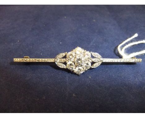 A white gold mounted diamond cluster brooch of flowerhead and foliate design, 6.1 cm long,  approx 1.4 ct total  CONDITION RE