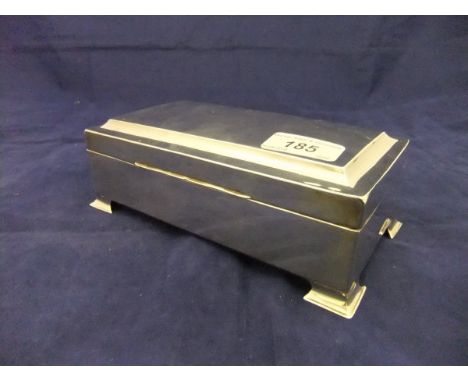 A 20th Century silver sheathed cigarette box with cedar lining on splayed bracket feet (marks rubbed)