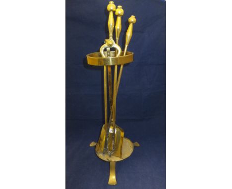 A brass oil lamp, fireside companion set, three pairs of brass candlesticks, three single brass candlesticks, brass verriere,