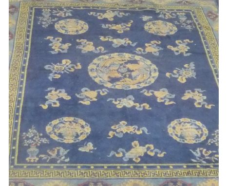 A Chinese carpet with all-over dragon decoration on a navy blue ground, 350 cm x 280 cm CONDITION REPORTS Considerable uneven