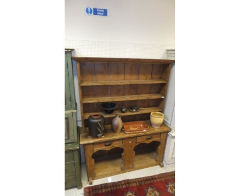 A 19th Century Continental pine dresser, the boarded plate rack above two drawers over a single shelf