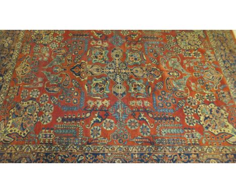 A Ziegler Mahal carpet, the terracotta ground with stylised floral and foliate motifs in blue, cream, cinnamon and terracotta