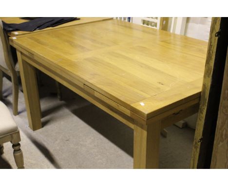 A modern rectangular light oak draw leaf dining table on square supports (TO BE SOLD WITH THE OPTION ON LOT 550)