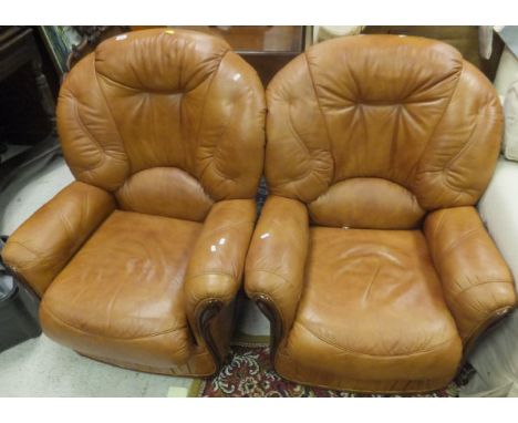 A pair of modern light tan / brown armchairs