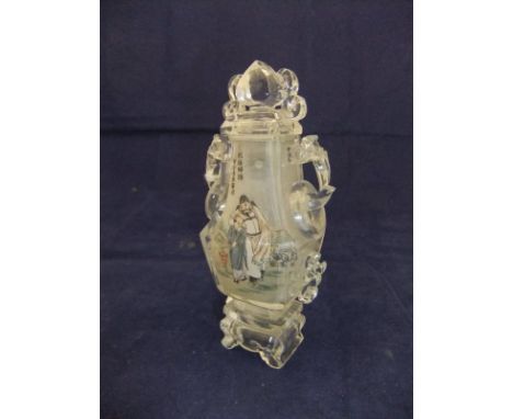 A Chinese clear cut rock crystal dressing table bottle of slab cut baluster form with ring handles and scrolling decoration t