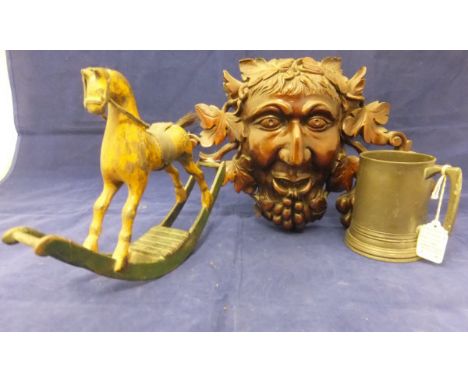 A collection of various treenware including a miniature painted rocking horse, wall plaque of Bacchus, carved figure of The M