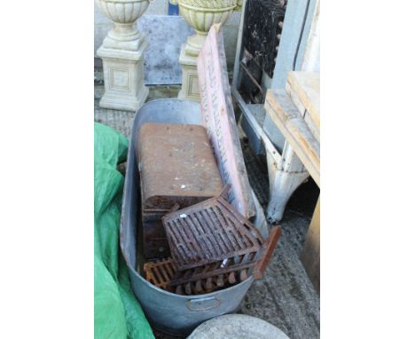 A two man saw, a zinc bath, a tin trunk, a scythe, a wooden sign and a fire grate