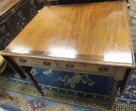 A late Regency mahogany sofa table, the rounded rectangular drop-leaf top rosewood cross-banded and with moulded edge over tw