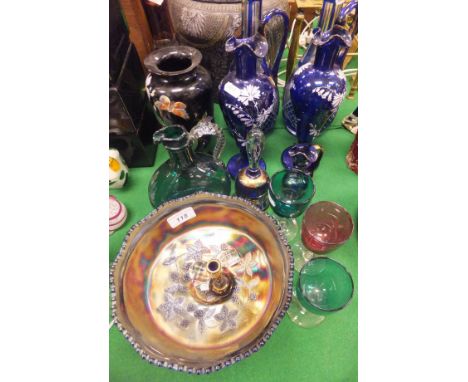 A pair of Bohemian blue overlaid cut glass decanters, a similar amethyst overlaid cut glass decanter, a pair of Bristol Blue 