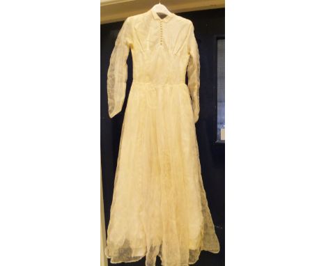 A vintage mid 20th Century wedding dress with pearl button detail