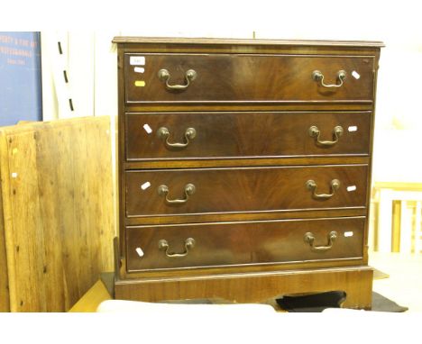 A reproduction mahogany chest of four graduated drawers on bracket feet and an Indian hardwood rectangular coffee table