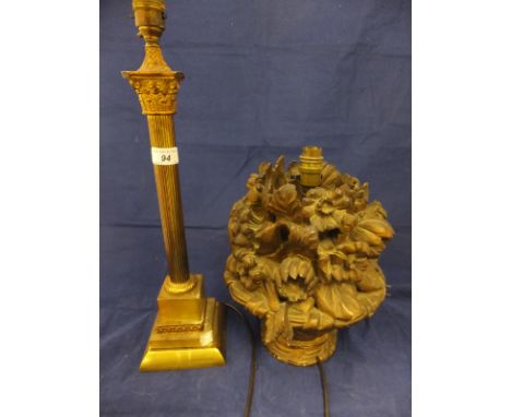 A brass table lamp in the form of a Corinthian column, together with a carved wooden bodied table lamp in the form of flowers