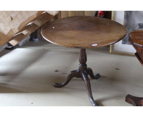 A Victorian oak tilt-top table, the circular top raised on a turned and ringed pedestal to tripod base