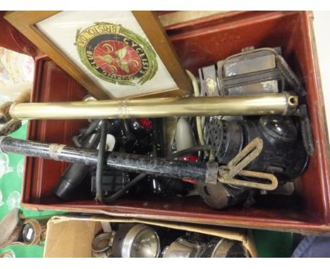 A tin trunk containing various lamps including "The Crescent Lamp" (x 3) by Dolan & Co. of London, various other cycle lamps,