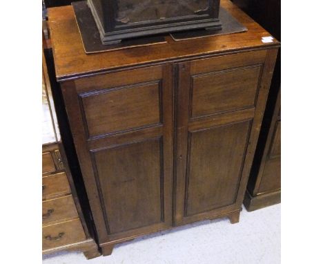 An early 19th Century mahogany specimen cabinet, the plain top with applied reeded edge over two fielded panelled cupboard do