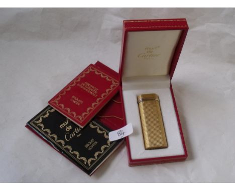 A boxed Cartier Briquet lighter with certificate of guarantee