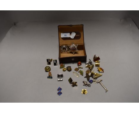 A selection of gentleman's cuff links and enamel pin badges