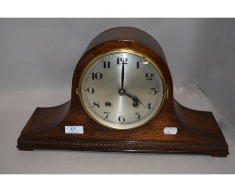 A 1930's oak arched mantel clock, nicely moulded to the base.