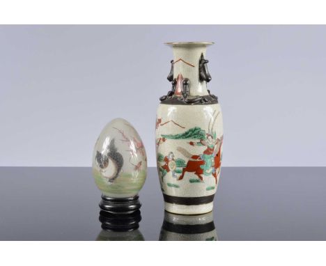 A mid 20th century Chinese porcelain vase and a reverse painted glass egg,  25.5cm high, with crackle glaze, and the egg with