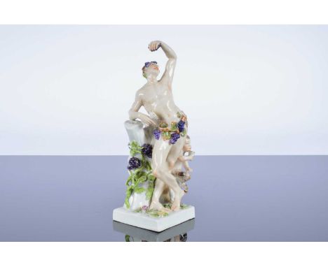 A Dresden porcelain figural group, 25cm, modelled as Bacchus and a faun, marked to base, with some damage to the vine on the 