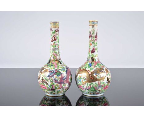 A pair of Chinese porcelain bottle vases, 23cm high, underglaze blue with enamel painted decoration, one with two chips to ba
