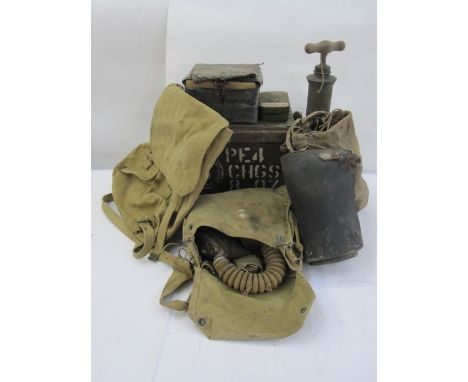 Three WWII gas masks, an ammunition box, a pump, a rucksack, two metal boxes of film cartridges, a pair of gaiters and three 