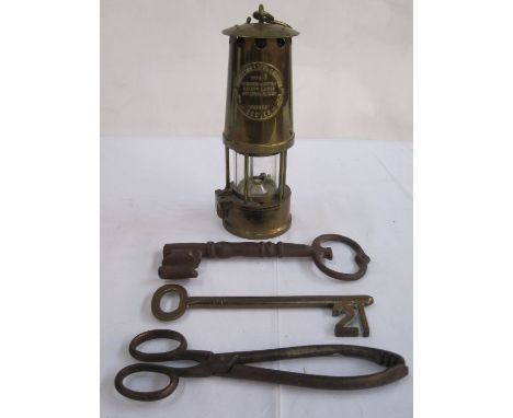 Large '21' key, another large key, a miner's lamp 'The Protector Lamp and Lighting Company Limited' and a pair of tongs (4) 