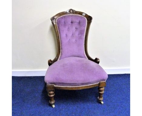 Victorian walnut ladies salon chair, the shell carved top rail above a button upholstered back and padded serpentine seat on 