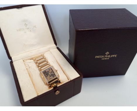 Gent's Patek Philippe gold bracelet watch, quartz with bronze dial, diamond set chapters and button with flanking bands of br