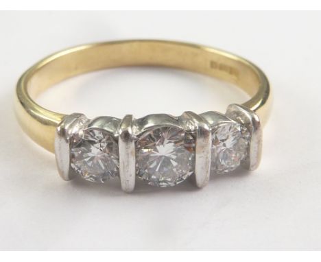 Diamond three stone, the largest brilliant approx .25ct ring in 18ct gold. Size 'K'. Condition Report. Weight: 2.9g.