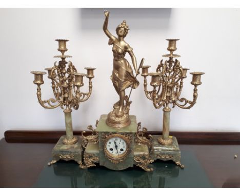 Early 20th century green onyx and spelter garniture comprising a clock and pair of five light candelabra. 57cm and 48cm.  